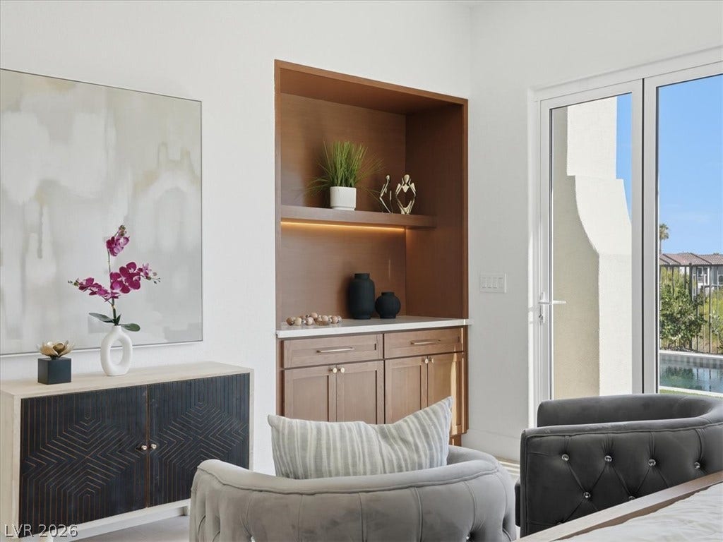 3074 Soft Horizon Way, Las Vegas, NV 89135 A well-lit bedroom with built-in features and access to an outdoor patio.