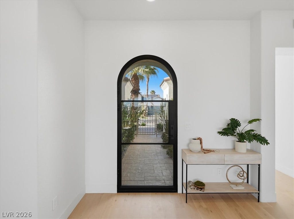3074 Soft Horizon Way, Las Vegas, NV 89135 An arched glass entry door welcomes you to this sophisticated home with light wood flooring and crisp white walls.
