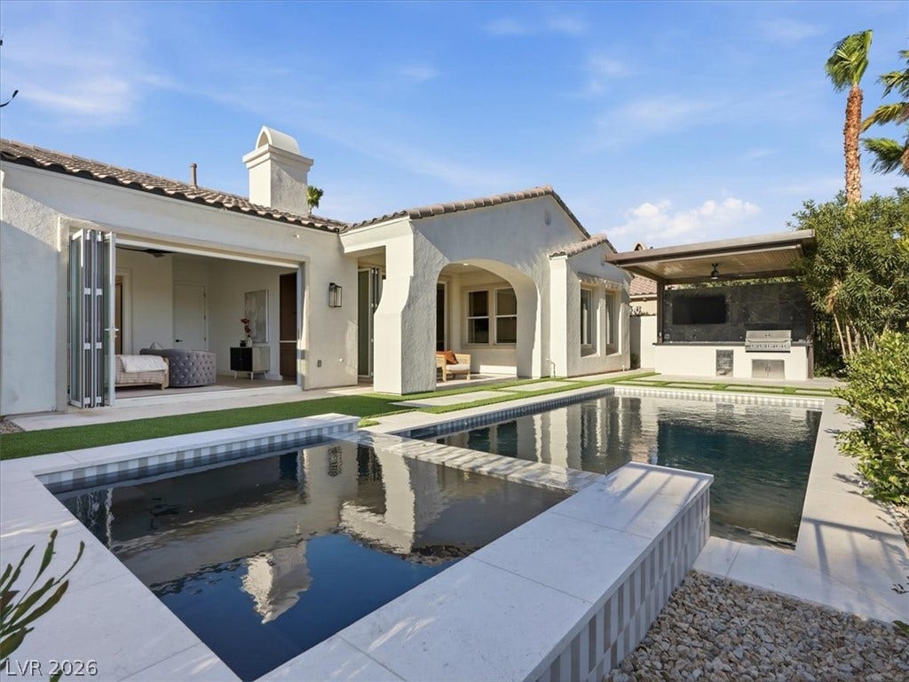 3074 Soft Horizon Way, Las Vegas, NV 89135 An inviting pool area complements this home's seamless indoor-outdoor living, complete with an outdoor kitchen.
