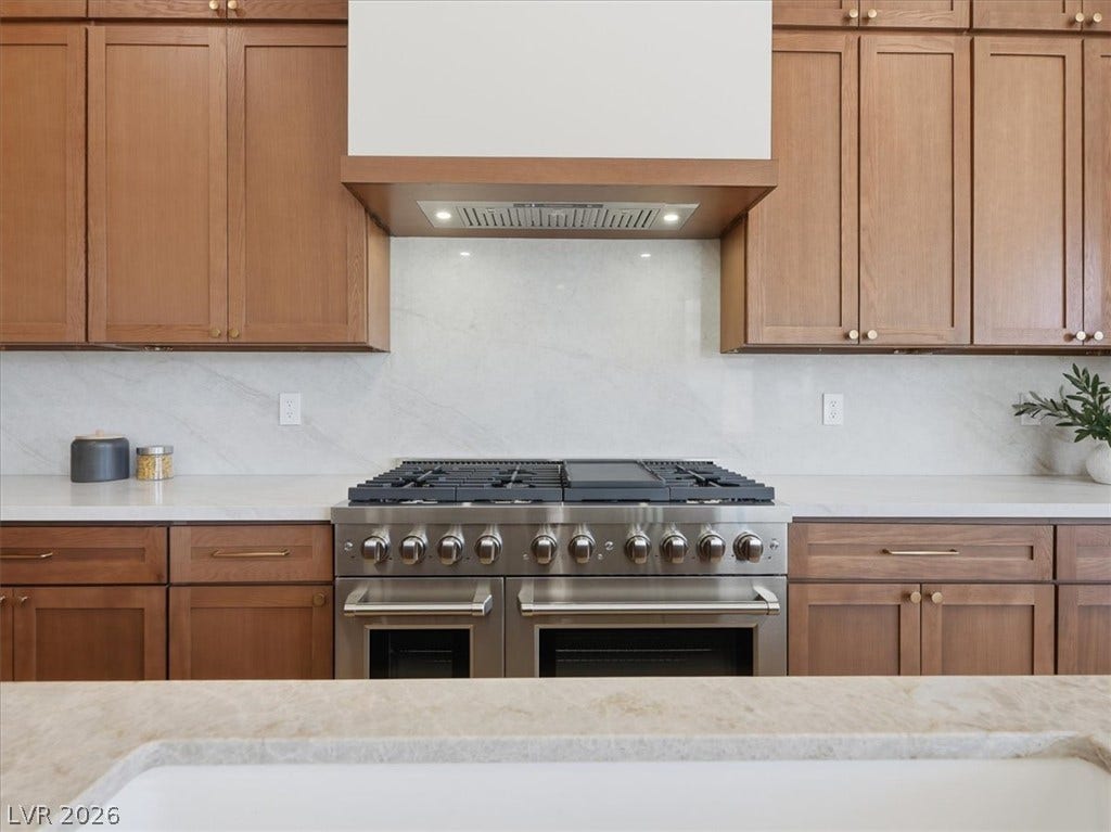 3074 Soft Horizon Way, Las Vegas, NV 89135 A well-appointed kitchen showcasing a professional-grade range and rich cabinetry.