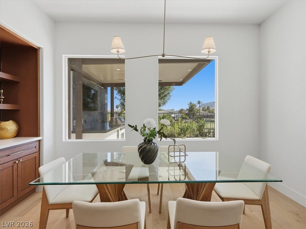 3074 Soft Horizon Way, Las Vegas, NV 89135 A sleek dining area with ample natural light offers scenic outdoor views.