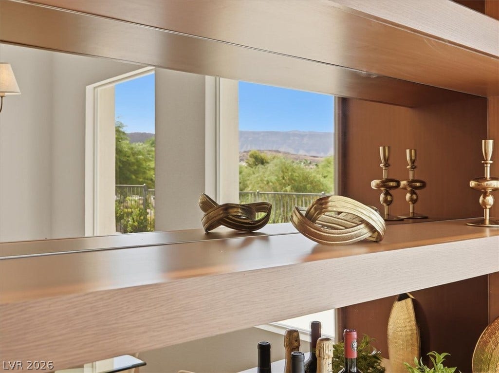 3074 Soft Horizon Way, Las Vegas, NV 89135 Reflective surfaces capture mountain and desert panoramas, enhancing this bright interior's sense of depth.