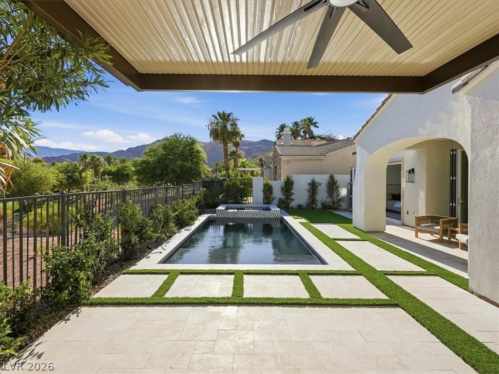 3074 Soft Horizon Way, Las Vegas, NV 89135 An inviting outdoor living space features a rectangular pool, a soothing spa, and a covered patio with an outdoor ceiling fan.