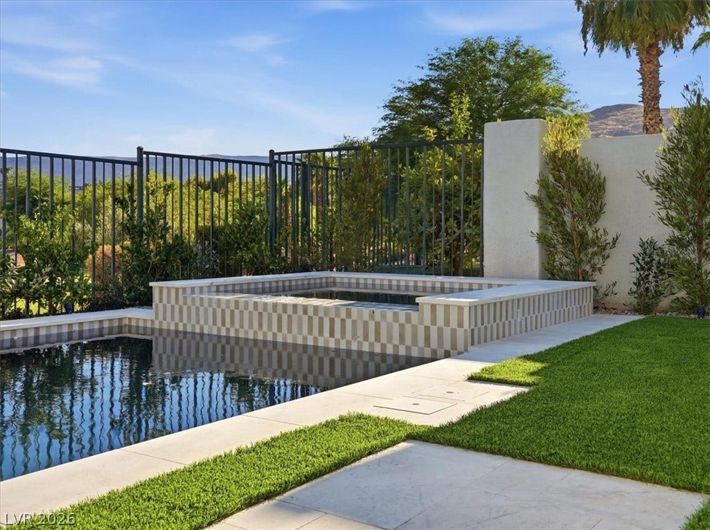3074 Soft Horizon Way, Las Vegas, NV 89135 An inviting private pool and spa await, complemented by manicured turf and mountain views.