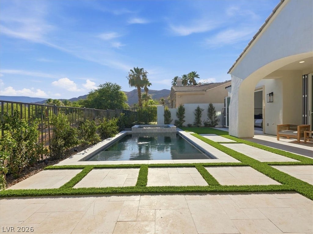 3074 Soft Horizon Way, Las Vegas, NV 89135 Lounge poolside on the patio, enjoying mountain views and a fenced yard with a spa.