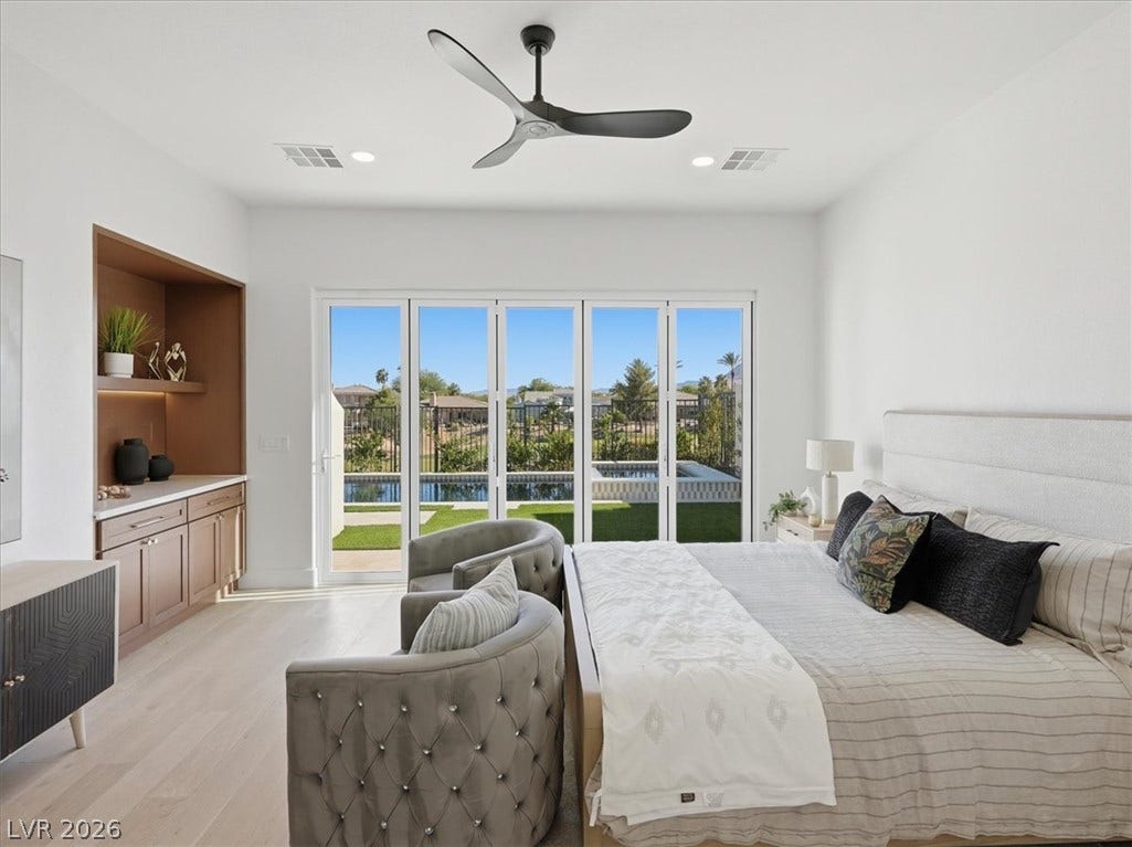 3074 Soft Horizon Way, Las Vegas, NV 89135 Floor-to-ceiling glass doors offer seamless indoor-outdoor living, complementing the spacious layout.