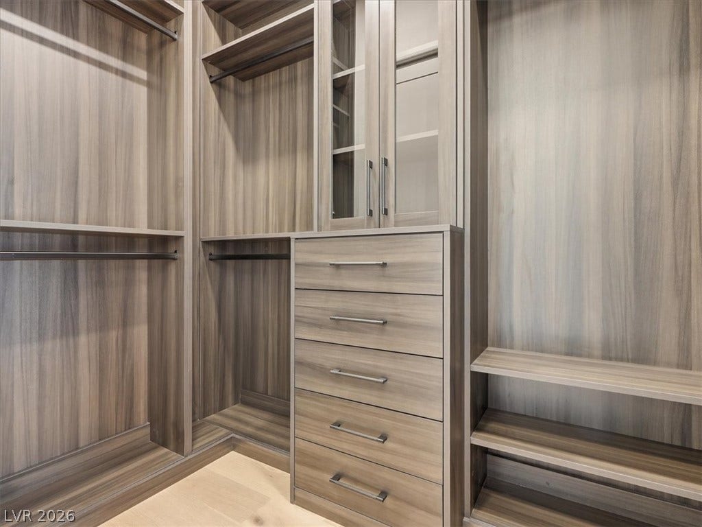 3074 Soft Horizon Way, Las Vegas, NV 89135 Ample storage solutions abound in this well-appointed closet, featuring built-in drawers and hanging rods.