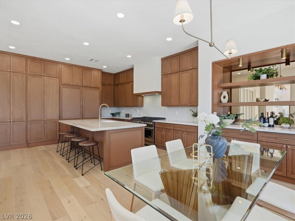 3074 Soft Horizon Way, Las Vegas, NV 89135 This kitchen boasts an inviting island with a breakfast bar, complemented by ample cabinetry and modern cooking appliances.