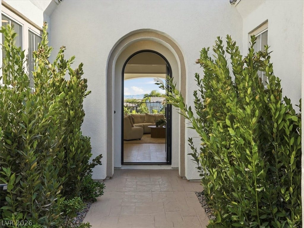 3074 Soft Horizon Way, Las Vegas, NV 89135 An inviting arched doorway welcomes you to a refined living space with views of the natural landscape.