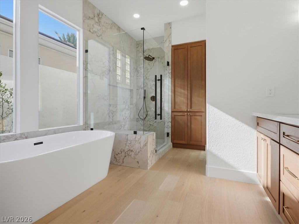 3074 Soft Horizon Way, Las Vegas, NV 89135 Luxurious spa-like primary bathroom features a standalone soaking tub and a spacious glass-enclosed shower.