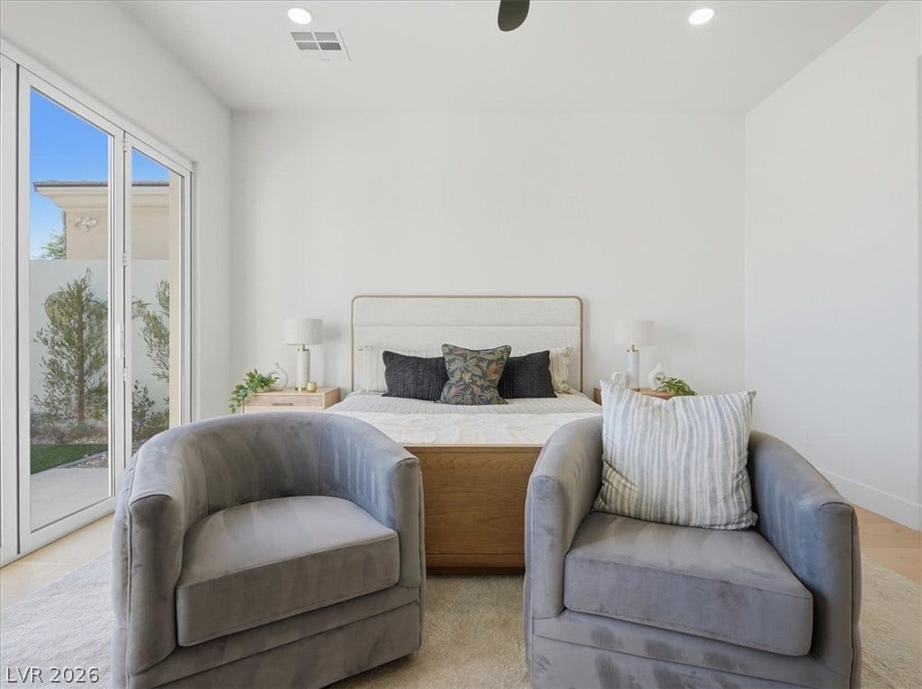 3074 Soft Horizon Way, Las Vegas, NV 89135 Sliding glass doors offer access to the outdoors, complementing the well-lit, serene atmosphere of this bedroom.