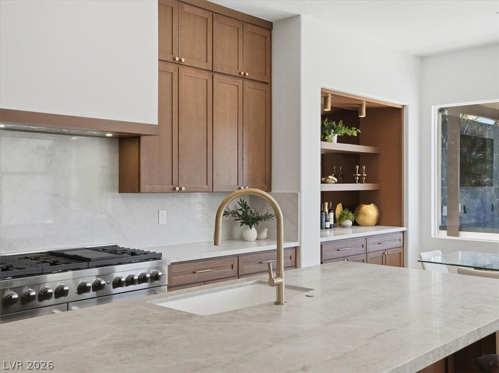 3074 Soft Horizon Way, Las Vegas, NV 89135 A refined kitchen island with a brass faucet and integrated sink anchors this stylish culinary space.