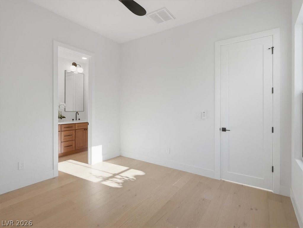 3074 Soft Horizon Way, Las Vegas, NV 89135 Bright hardwood floors and clean white walls offer a spacious, modern interior with natural light.