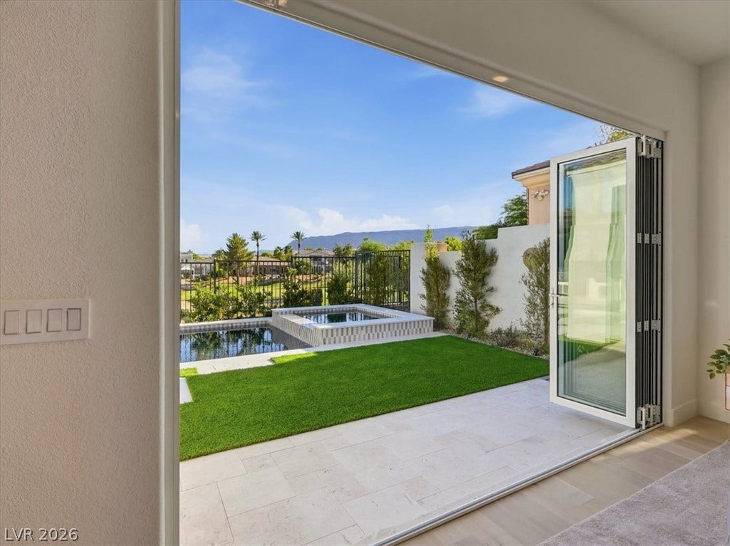 3074 Soft Horizon Way, Las Vegas, NV 89135 Seamless indoor-outdoor living with folding glass doors opening to a tranquil private pool and spa.
