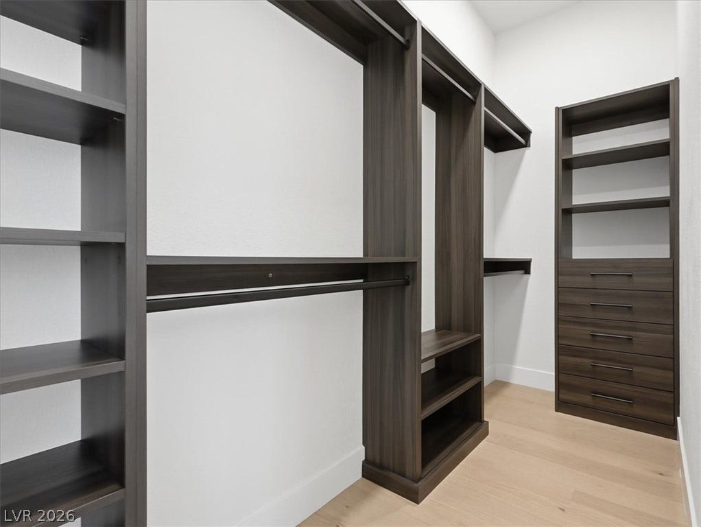3074 Soft Horizon Way, Las Vegas, NV 89135 Ample built-in storage solutions create an organized and elegant walk-in closet space.