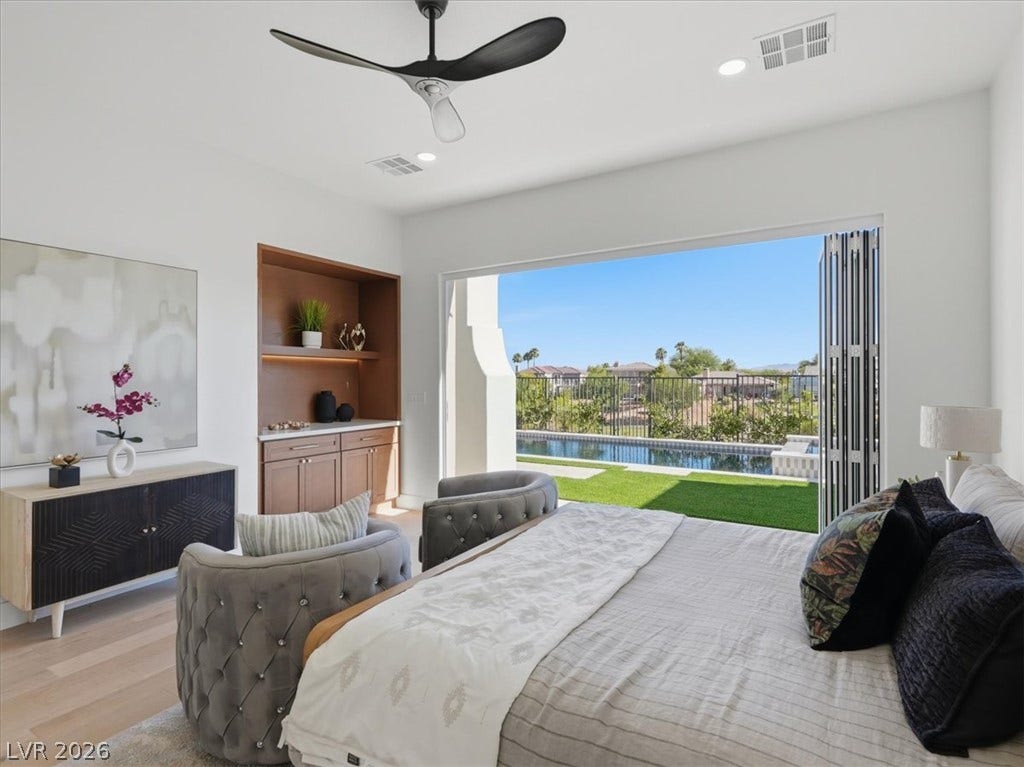 3074 Soft Horizon Way, Las Vegas, NV 89135 Retreat to a primary suite featuring expansive glass doors opening to a private pool and manicured lawn.