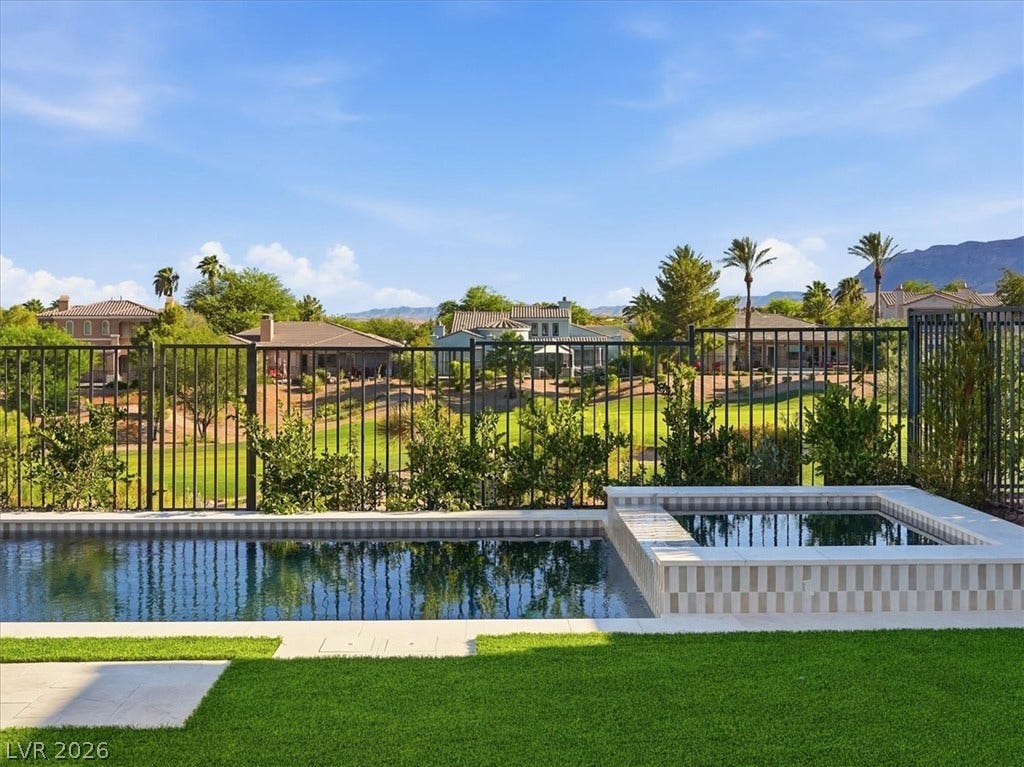 3074 Soft Horizon Way, Las Vegas, NV 89135 A tranquil backyard oasis features a glistening pool and a luxurious spa, all set against a backdrop of distant mountains.