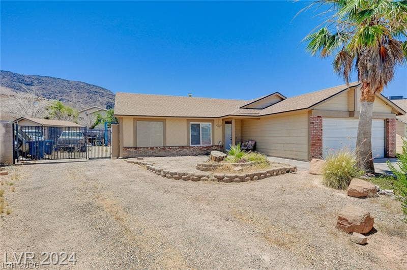 478 Potomac Street, Henderson, NV 89015 Classic single-story desert architecture features brick accents and a prominent two-car garage.