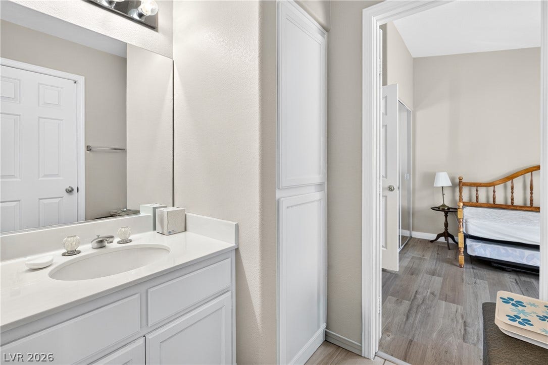 4633 Sophia Way, North Las Vegas, NV 89032 An open doorway links this modern vanity area with the adjoining bedroom.