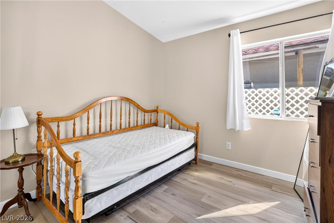 4633 Sophia Way, North Las Vegas, NV 89032 Slanted ceilings and wood-style flooring elevate this comfortable bedroom space.