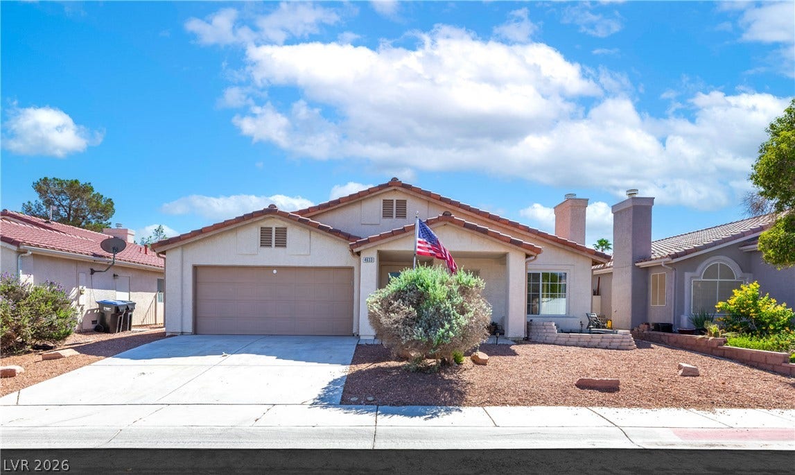 4633 Sophia Way, North Las Vegas, NV 89032 Tiled roofing and a concrete driveway define the traditional facade of this single-story home.