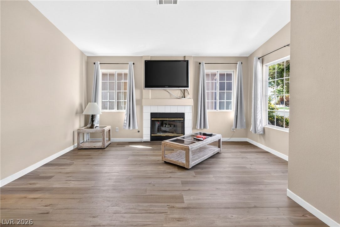 4633 Sophia Way, North Las Vegas, NV 89032 Natural light streams across the handsome wood floors and fireplace of this welcoming living space.