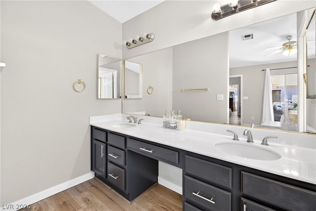 4633 Sophia Way, North Las Vegas, NV 89032 A spacious vanity area features dual sinks, ample cabinet space, and durable wood-look flooring.