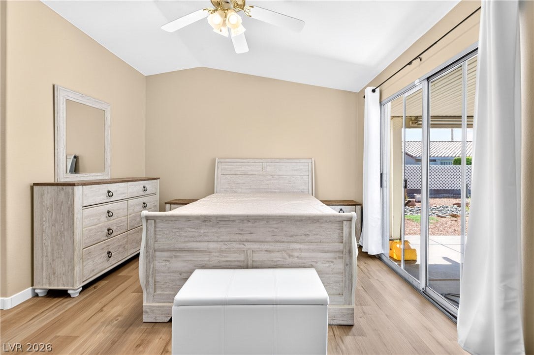4633 Sophia Way, North Las Vegas, NV 89032 Sliding glass doors open directly to the patio from this vaulted bedroom with wood flooring.