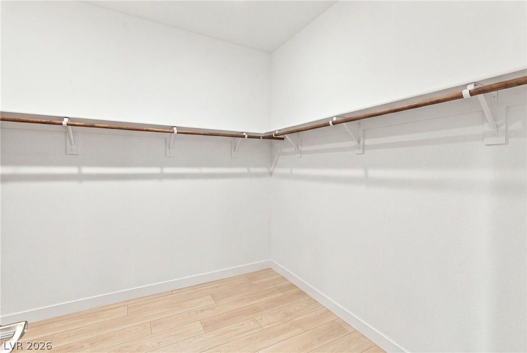 709 Emerson Creek Court, North Las Vegas, NV 89084 Clothes are virtually removed. Ample closet space features light-toned wood flooring and a convenient hanging rod system.