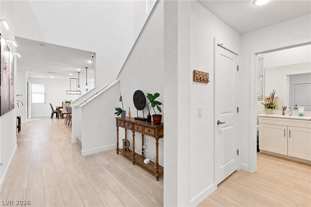 709 Emerson Creek Court, North Las Vegas, NV 89084 A well-lit entry hall with wood-look tile flooring flows into the open-concept living and dining areas.