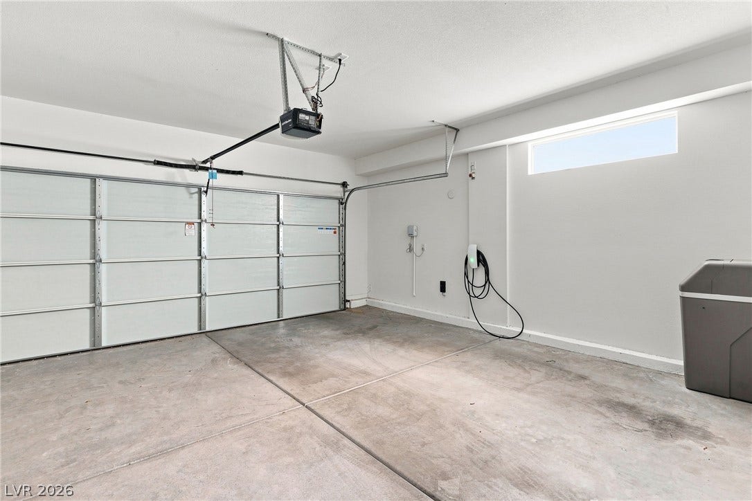 709 Emerson Creek Court, North Las Vegas, NV 89084 Secure parking and storage await in this clean garage with a remote-controlled door and electric vehicle charging.