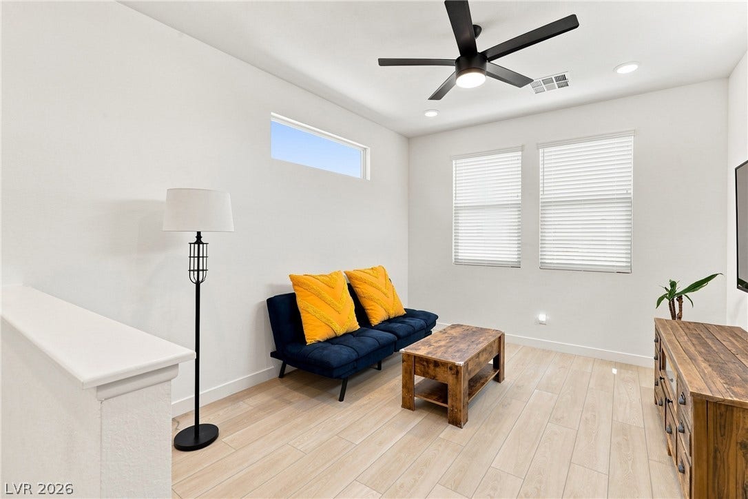 709 Emerson Creek Court, North Las Vegas, NV 89084 Natural light illuminates this versatile living area, complemented by recessed lighting and a ceiling fan.