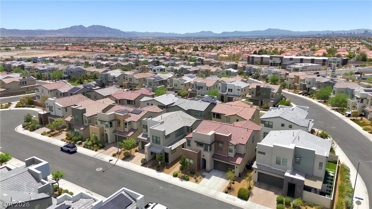 709 Emerson Creek Court, North Las Vegas, NV 89084 An aerial perspective reveals a vibrant community with varied architectural styles under a vast, open sky.