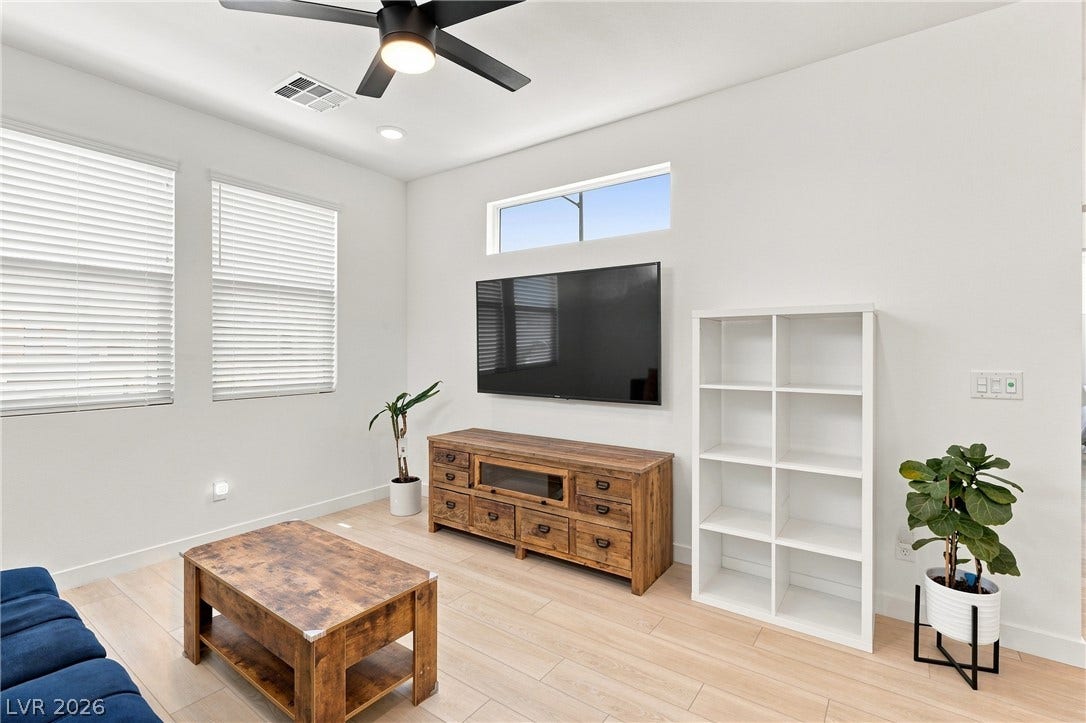 709 Emerson Creek Court, North Las Vegas, NV 89084 A living room with light wood floors and a contemporary design invites relaxation.