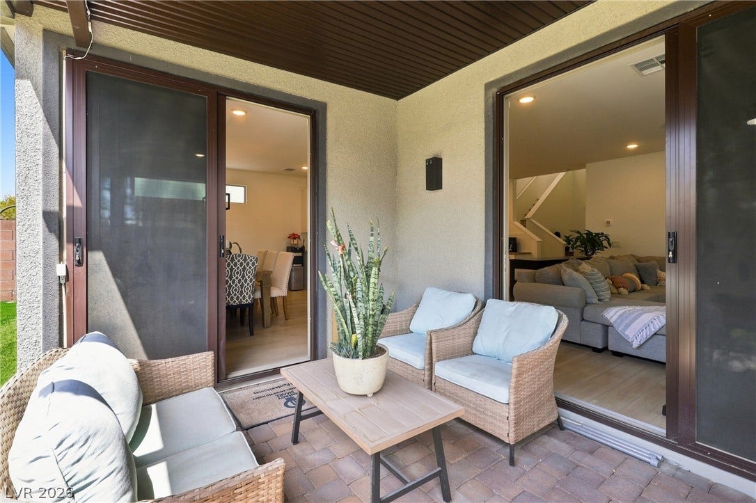 709 Emerson Creek Court, North Las Vegas, NV 89084 An inviting outdoor patio, perfect for relaxing, extends from the living space through sliding glass doors.