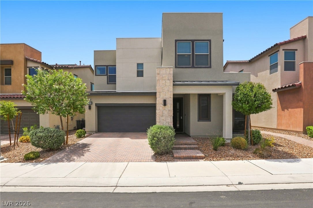 709 Emerson Creek Court, North Las Vegas, NV 89084 Modern desert architecture with a clean-lined stucco exterior and a neatly paved driveway.