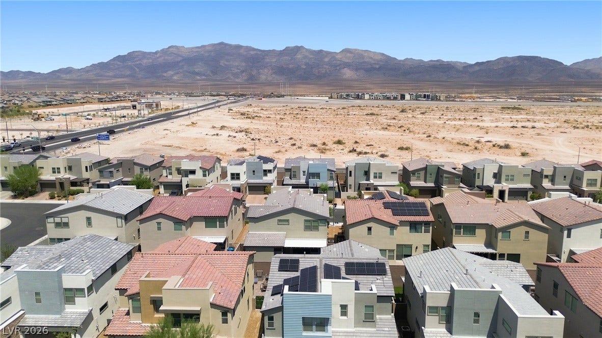 709 Emerson Creek Court, North Las Vegas, NV 89084 An aerial perspective showcases a vibrant desert community with mountain vistas.