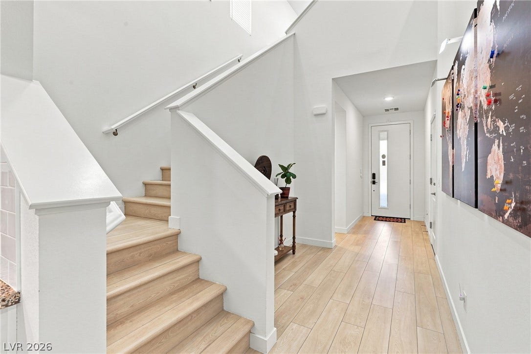 709 Emerson Creek Court, North Las Vegas, NV 89084 Natural wood flooring complements the staircase, leading to a well-lit entrance foyer.