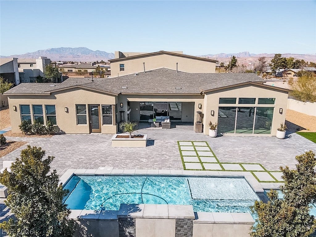 7851 W Wigwam Avenue, Las Vegas, NV 89113 Back of house featuring a mountain view, a patio, stucco siding, and outdoor lounge area