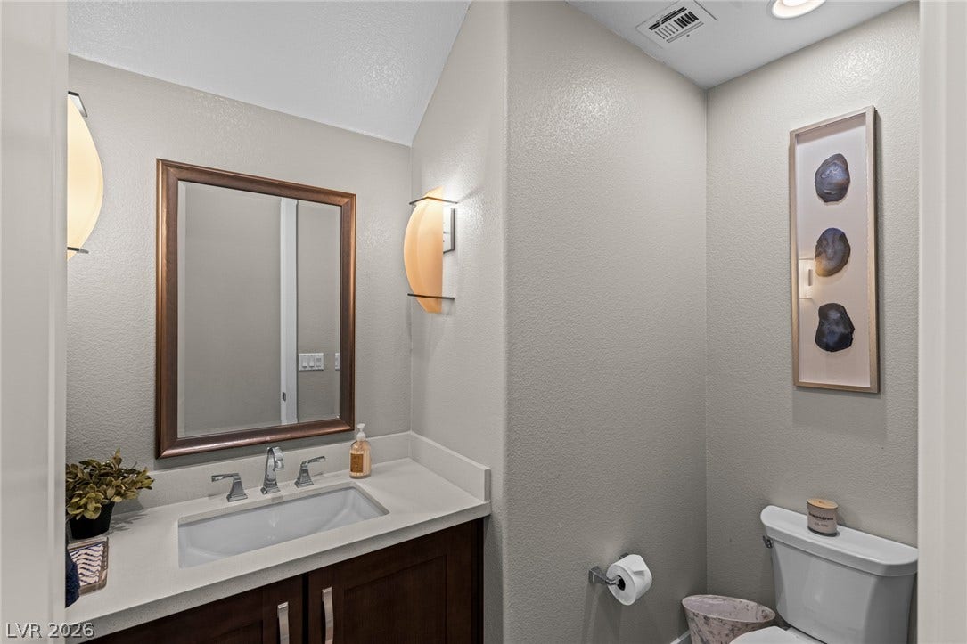 7851 W Wigwam Avenue, Las Vegas, NV 89113 Half bathroom with a textured wall and vanity
