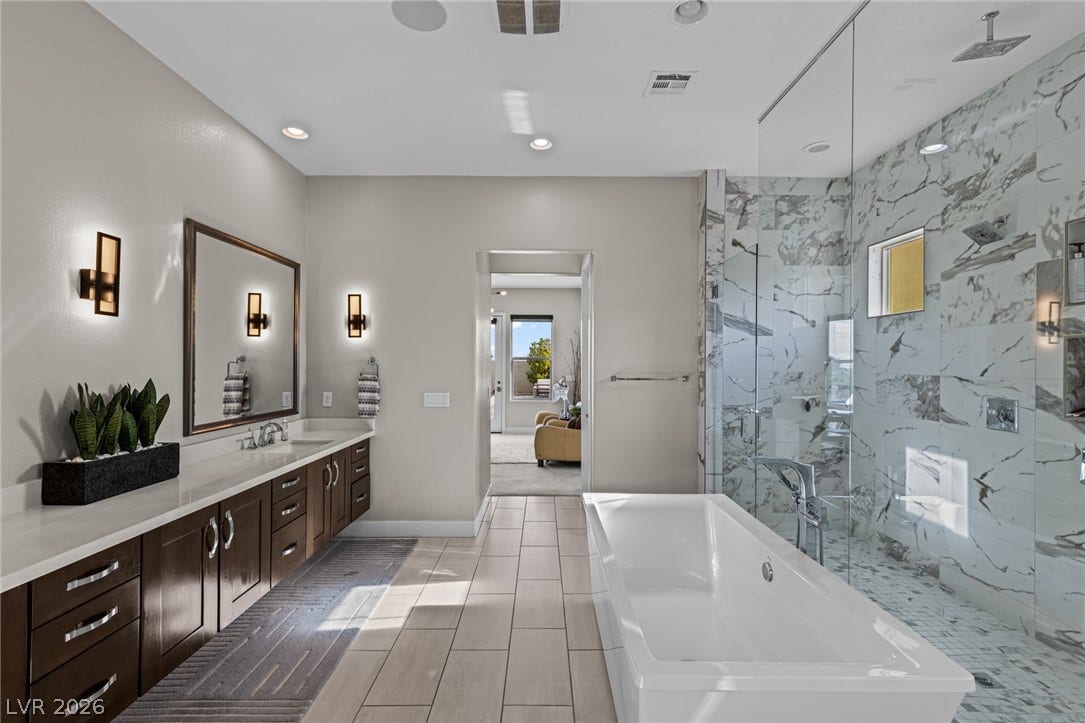 7851 W Wigwam Avenue, Las Vegas, NV 89113 Bathroom with a freestanding tub, vanity, recessed lighting, and a marble finish shower