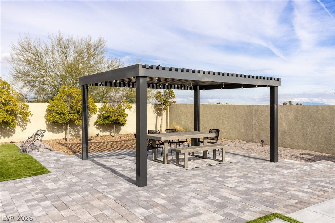 7851 W Wigwam Avenue, Las Vegas, NV 89113 Fenced backyard with outdoor dining area, a patio area, and a pergola
