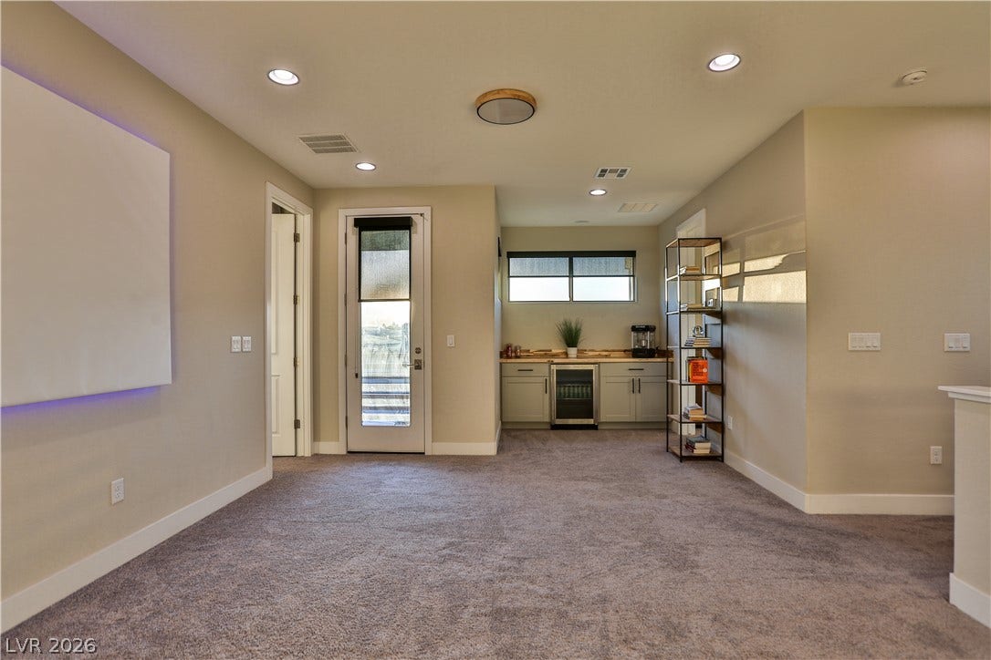 7851 W Wigwam Avenue, Las Vegas, NV 89113 Kitchen with light countertops, recessed lighting, dark carpet, wine cooler, and green cabinetry