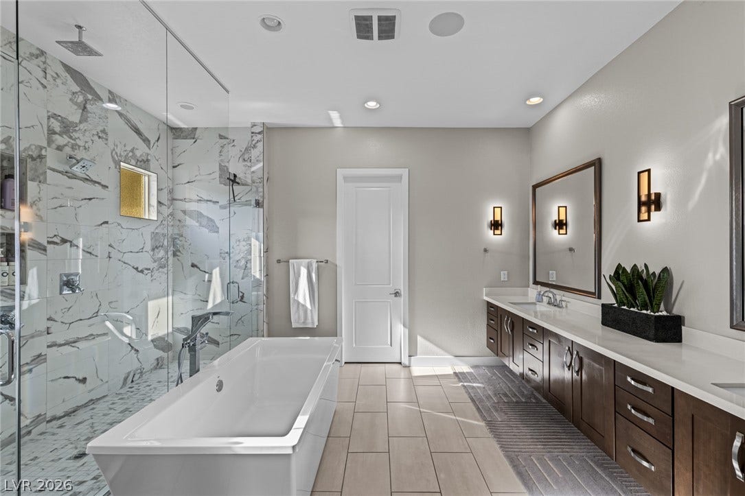 7851 W Wigwam Avenue, Las Vegas, NV 89113 Full bath featuring double vanity, a soaking tub, a marble finish shower, and recessed lighting