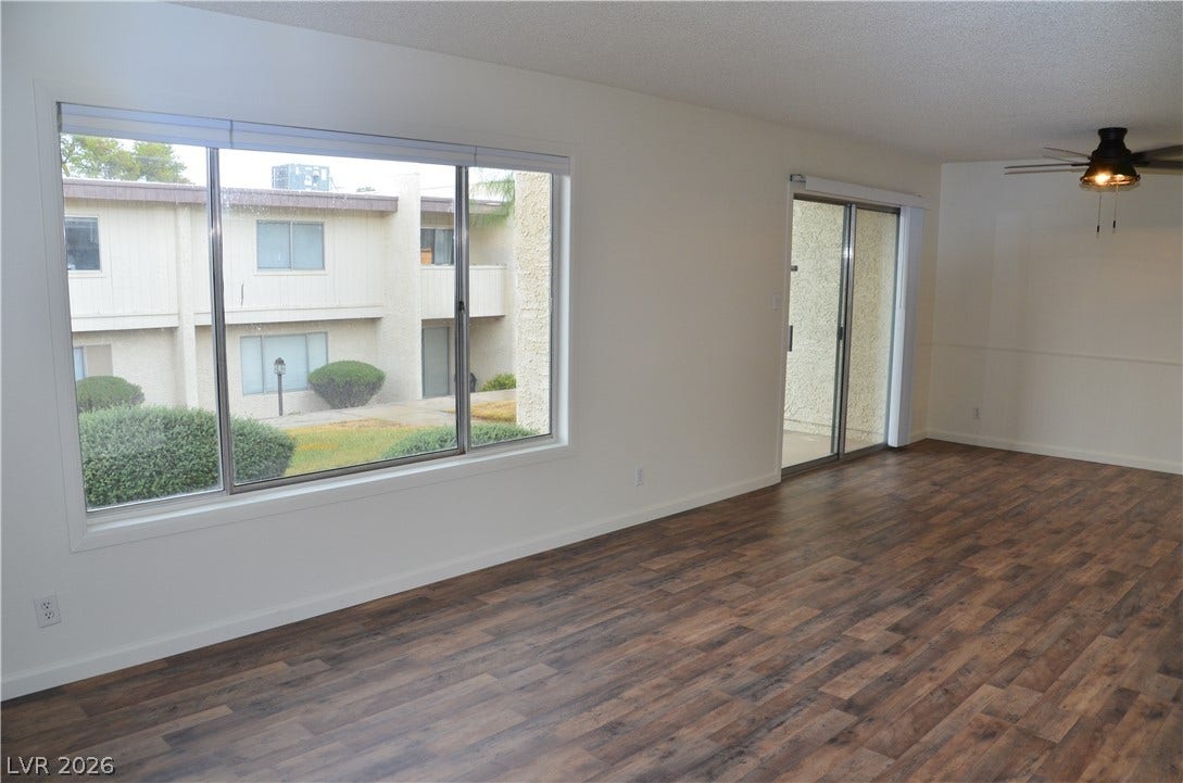 773 Cathy Lane, Henderson, NV 89015 Rich wood-look flooring and glass doors highlight this versatile living area.