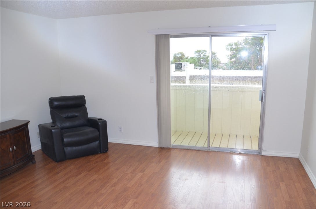 773 Cathy Lane, Henderson, NV 89015 Sliding glass doors lead out to a private balcony from this spacious living area.