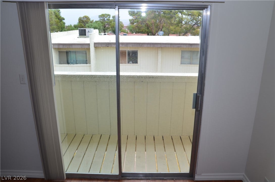 773 Cathy Lane, Henderson, NV 89015 A sliding glass door opens directly onto a private balcony with wood plank flooring.