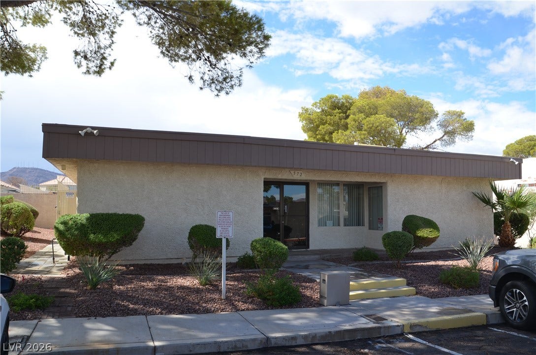 773 Cathy Lane, Henderson, NV 89015 Mid-century architectural styling defines this low-profile stucco commercial structure with mature desert landscaping.