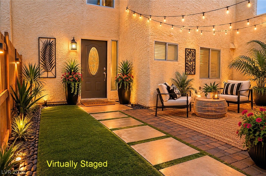 773 Cathy Lane, Henderson, NV 89015 An inviting courtyard entrance features textured stucco walls, paver stone pathways, and warm integrated lighting.