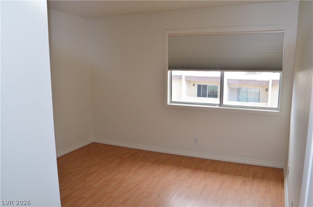 773 Cathy Lane, Henderson, NV 89015 Smooth wood-finish flooring and a wide picture window define this versatile interior space.